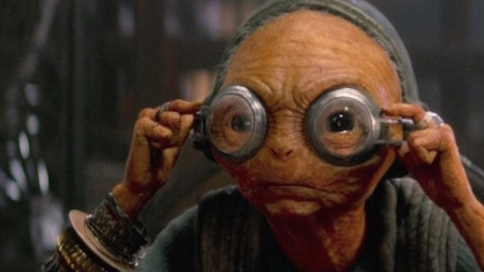 Maz Kenada adjusting her glasses.